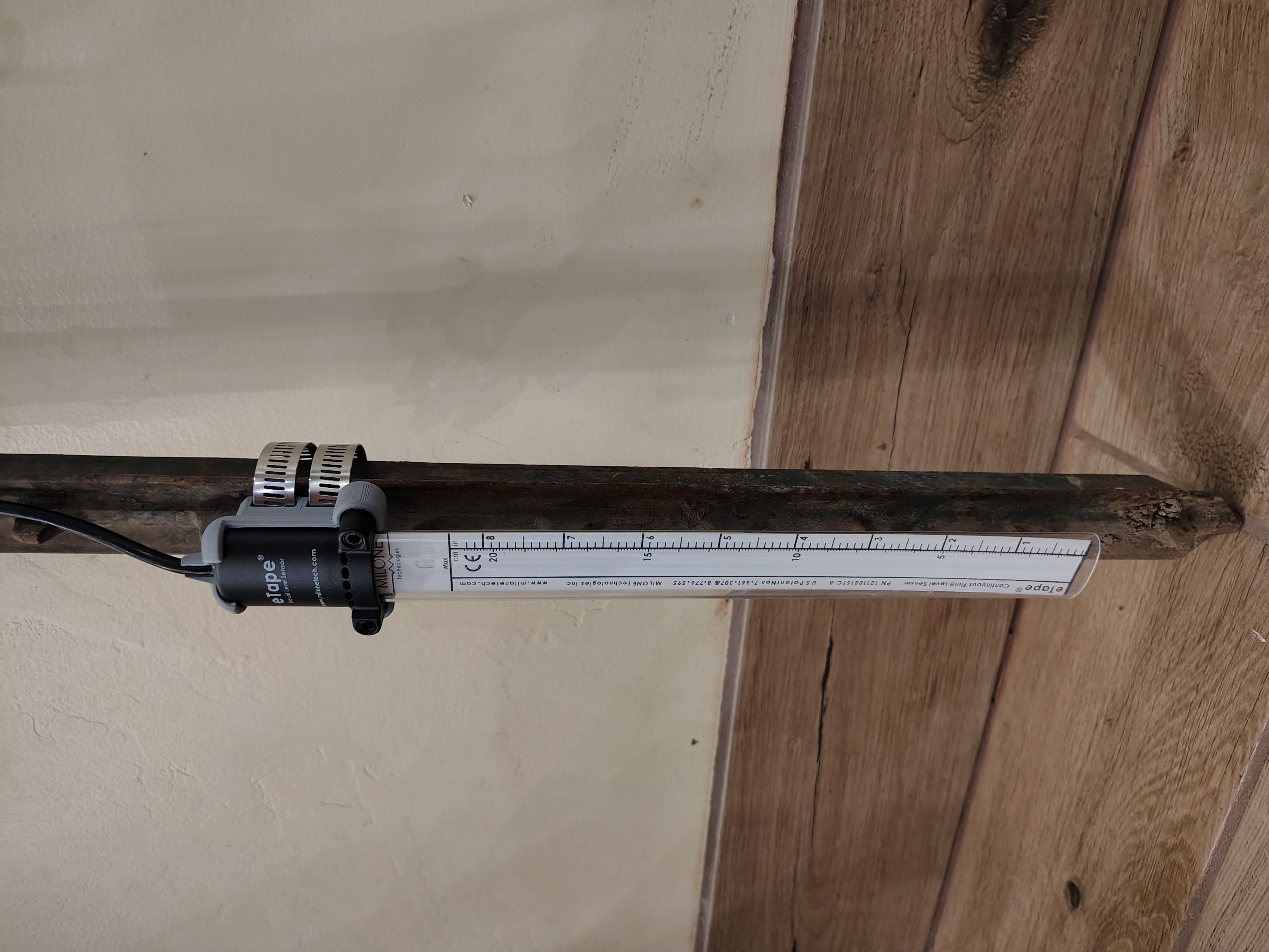 Measuring tape sensor mounted on post