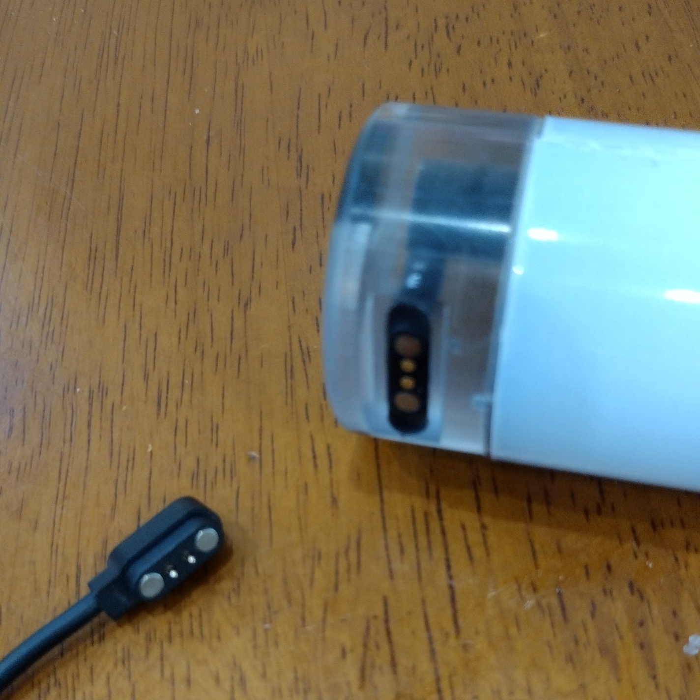 Magnetic charging cap with cord